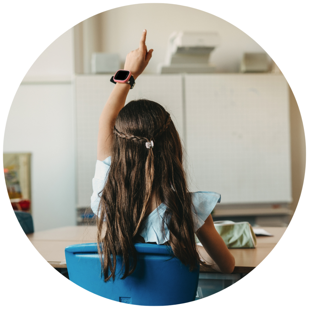 Barn med hånden oppe i skolen med et Xplora smartwatch på håndleddet.